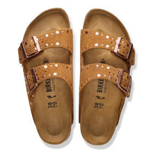 Pair of brown sandals with buckles on a white background