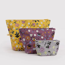 Three floral zippered pouches in yellow, purple, and gray