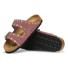 Pair of pink suede sandals with gold accents and gold buckles