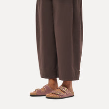 Birkenstock pink suede sandals styled with brown pants