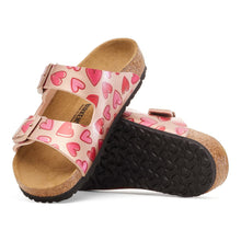 Pair of children's sandals with heart pattern