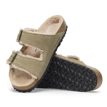 Pair of beige sandals with black soles