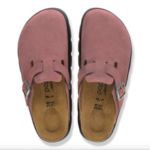 Birkenstock platform clog in pink suede with a black lug sole, cork footbed, and silver buckle