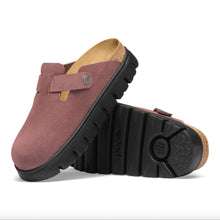 Birkenstock platform clog in pink suede with a black lug sole, cork footbed, and silver buckle