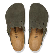 A pair of Birkenstock clogs in green suede