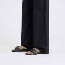 black eva sandals styled with black pants 