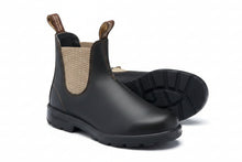 A leather Chelsea boot with a beige woven elastic side panel and pull tabs