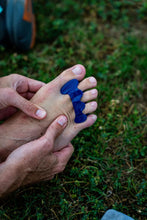 Person wearing a blue toe separator