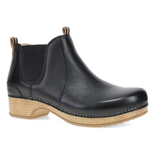 A black leather Chelsea-style ankle boot with a natural wedge heel