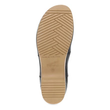 The outsole of a black boot,
