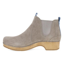 A taupe suede Chelsea ankle boot with a natural wedge heel and a small blue pull tab