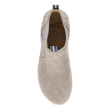 A taupe suede Chelsea ankle boot with a natural wedge heel and a small blue pull tab