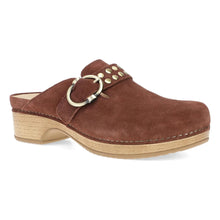 A brown suede clog shoe with a light wood block heel, featuring a decorative strap with gold rivets 