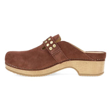A brown suede clog shoe with a cork-look stacked heel and a decorative strap adorned with gold-tone studs