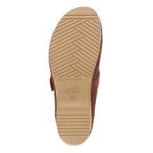 The tan rubber outsole of a brown slip-on shoe, showing a textured pattern