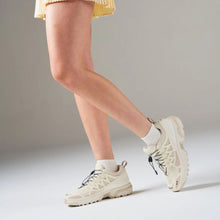 White socks styled with a yellow skirt 