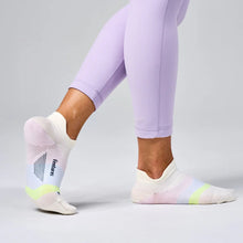 Person wearing light purple leggings and white socks with pastel accents 