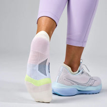 Person wearing light purple athletic shoes and socks 