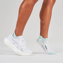 White sneakers and light greensocks worn by a person