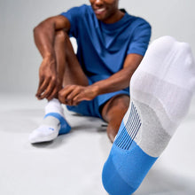 Person wearing blue socks 