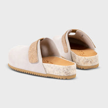 Pair of white slip on clogs with tan soles 