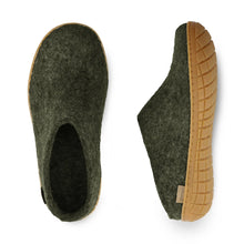 Pair of green slippers with brown soles 