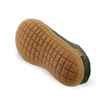 Close-up of a green clog sole with brown rubber tread pattern