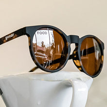 Sunglasses with reflective lenses on a white surface