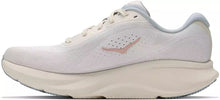 A white Nike running shoe with a light pink Swoosh logo and a thick cream-colored midsole, shown from a side profile view against a white background.