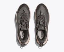 Gray athletic shoes with 'Hoka' branding 