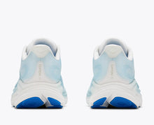 White and blue athletic shoes with blue soles 
