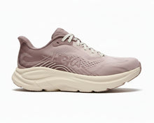 A Hoka running shoe in a dusty mauve pink colorway with a chunky cream-colored midsole and white laces