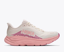 Pink and white running shoe with Hoka logo 