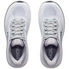 A pair of white and light gray HOKA running shoes.