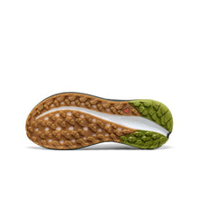 Close-up of a men's trail shoe sole with brown and green tread pattern