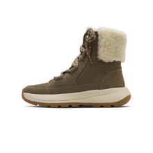 A Kizik winter boot in taupe brown with a cream-colored faux fur collar and a thick beige and brown sole