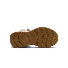 A close-up view of a boot's sole, showing a textured brown rubber tread 