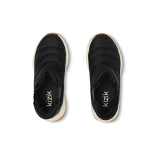 A black winter boot with a thick cream midsole and a brown rubber outsole