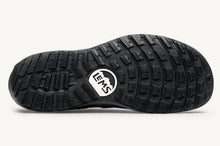 Black shoe sole with a visible brandon a white background