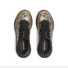 A gold and black running shoe, with a floral pattern. The shoe features a breathable mesh upper, a thick cushioned midsole, with vibram soles.