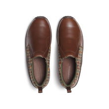 A slip-on shoe featuring a brown leather toe cap, a brown and dark brown houndstooth patterned tweed heel, and a dark brown sole.