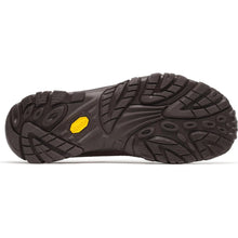 A close-up of a brown clogshoe sole showing its tread pattern and a small yellow Vibram logo