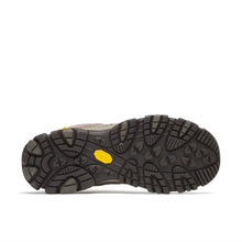The outsole of a hiking boot, showing a black Vibram tread pattern with a bright yellow Vibram logo 