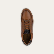 A brown leather lace-up shoe with a black heel accent