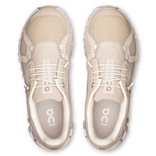 Pair of beige running shoes with white laces 