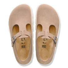Pair of beige sandals with a strap on a white background