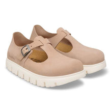 Pair of beige shoes with white soles on a white background