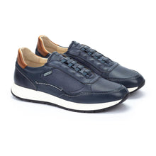 Pair of navy blue leather sneakers with beige accents