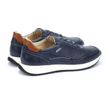 Pair of navy blue leather sneakers with brown accents 