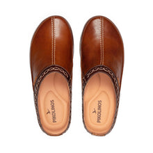 A pair of brown leather slip-on clogs . The brand name 'PIKOLINOS' is printed on the tan insoles.
